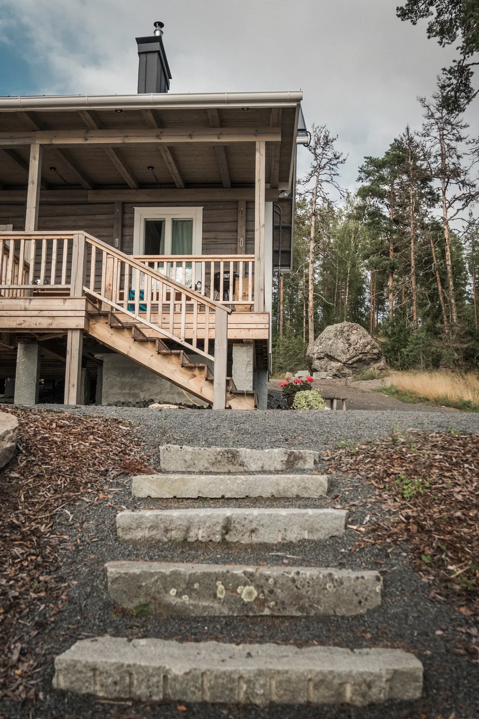 Luonnonkiviset portaat puurakennuksen pihassa